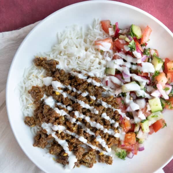 Ground beef bowl with rice and salad.