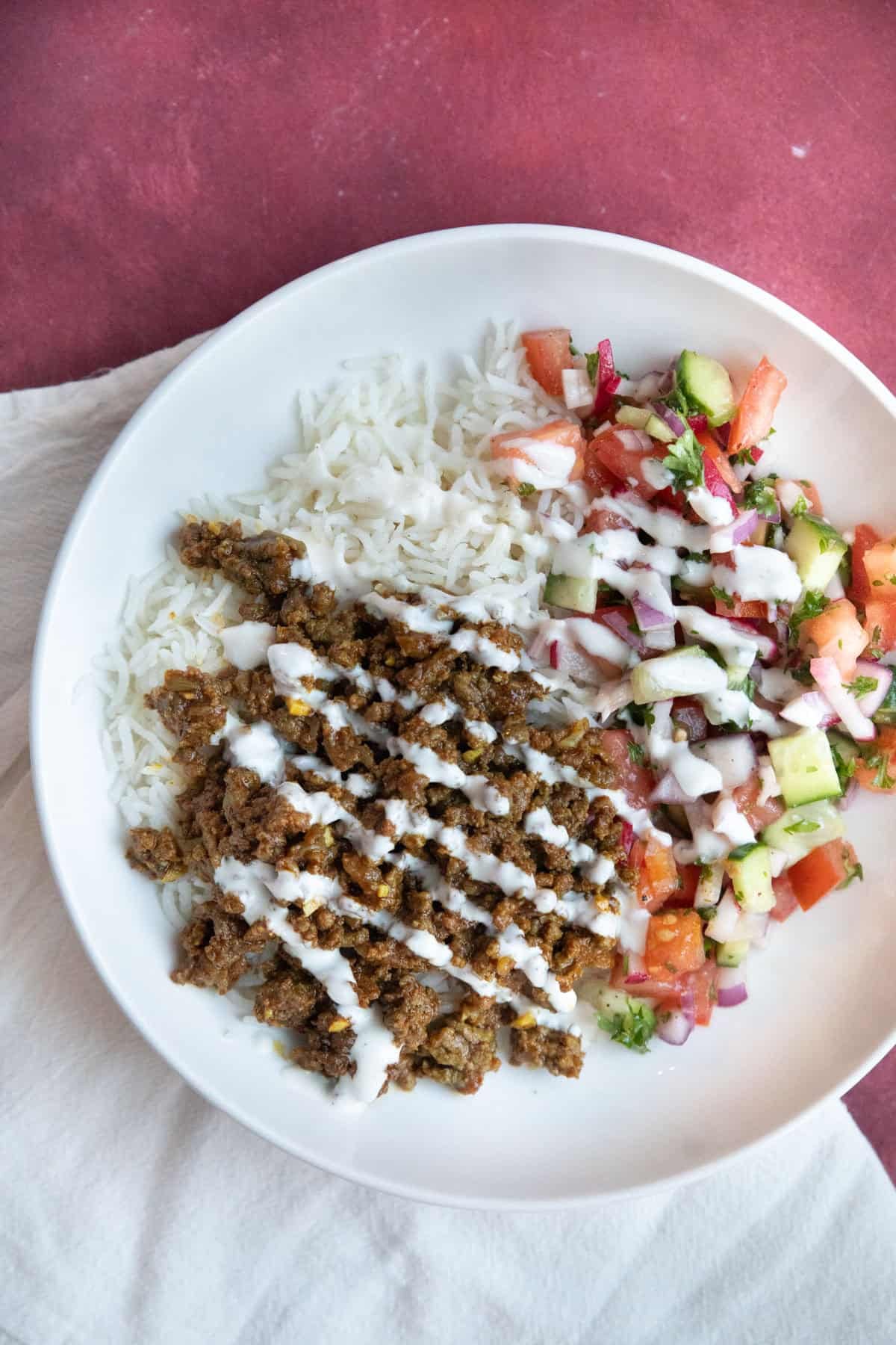 Ground beef bowl with rice and vegetables.