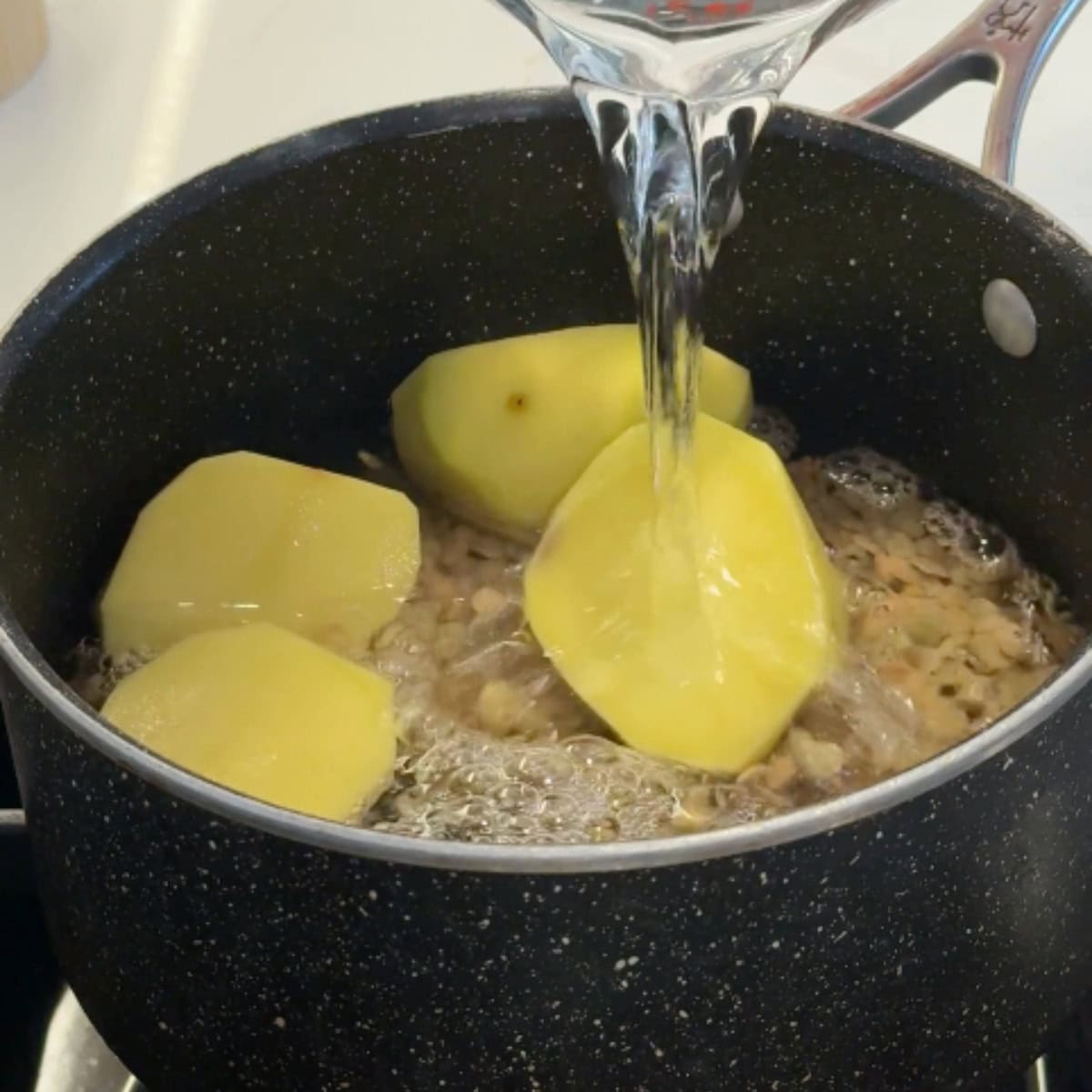Cook the lentils and potatoes in a pot.
