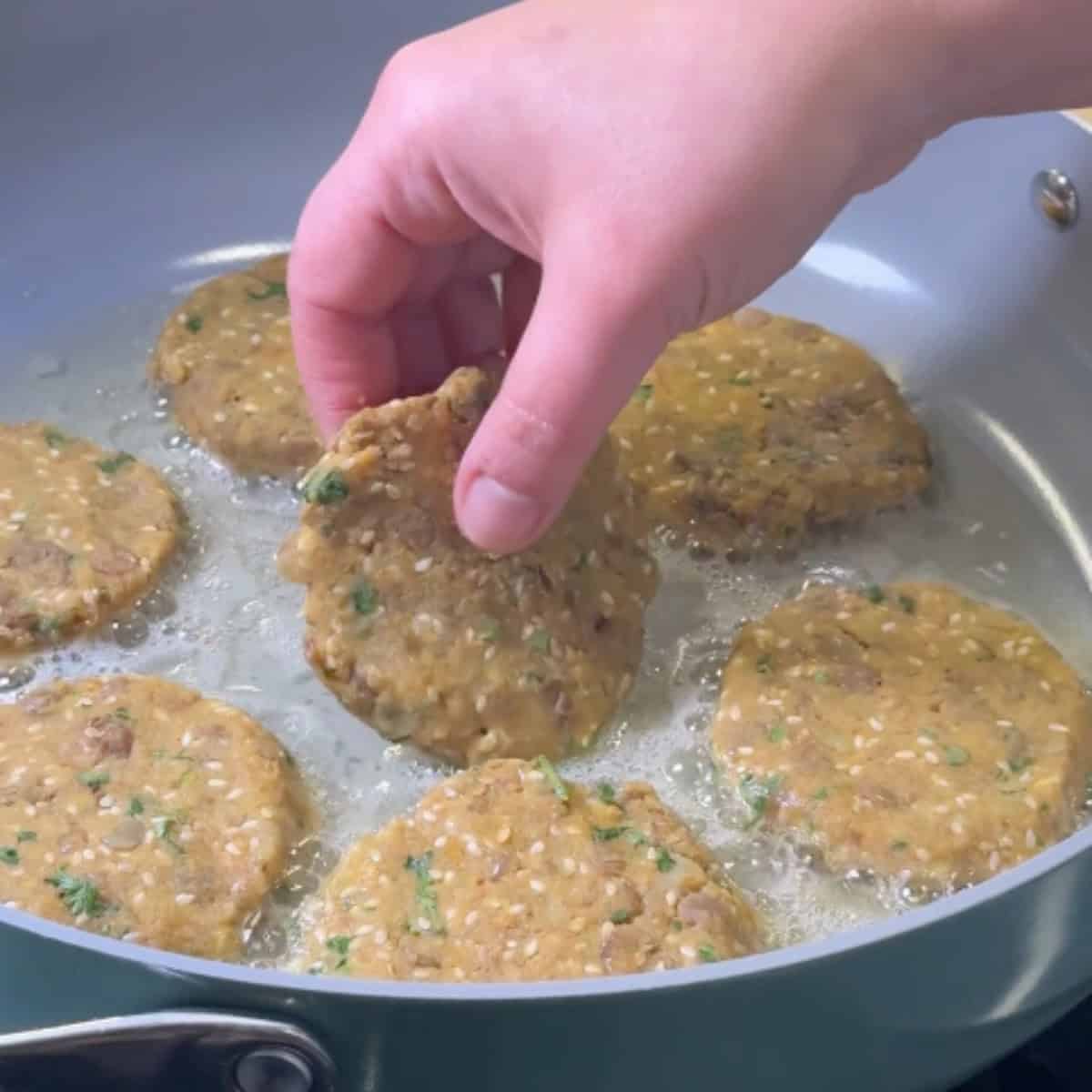 Place the lentil fritters in a pan heated over medium high heat. 