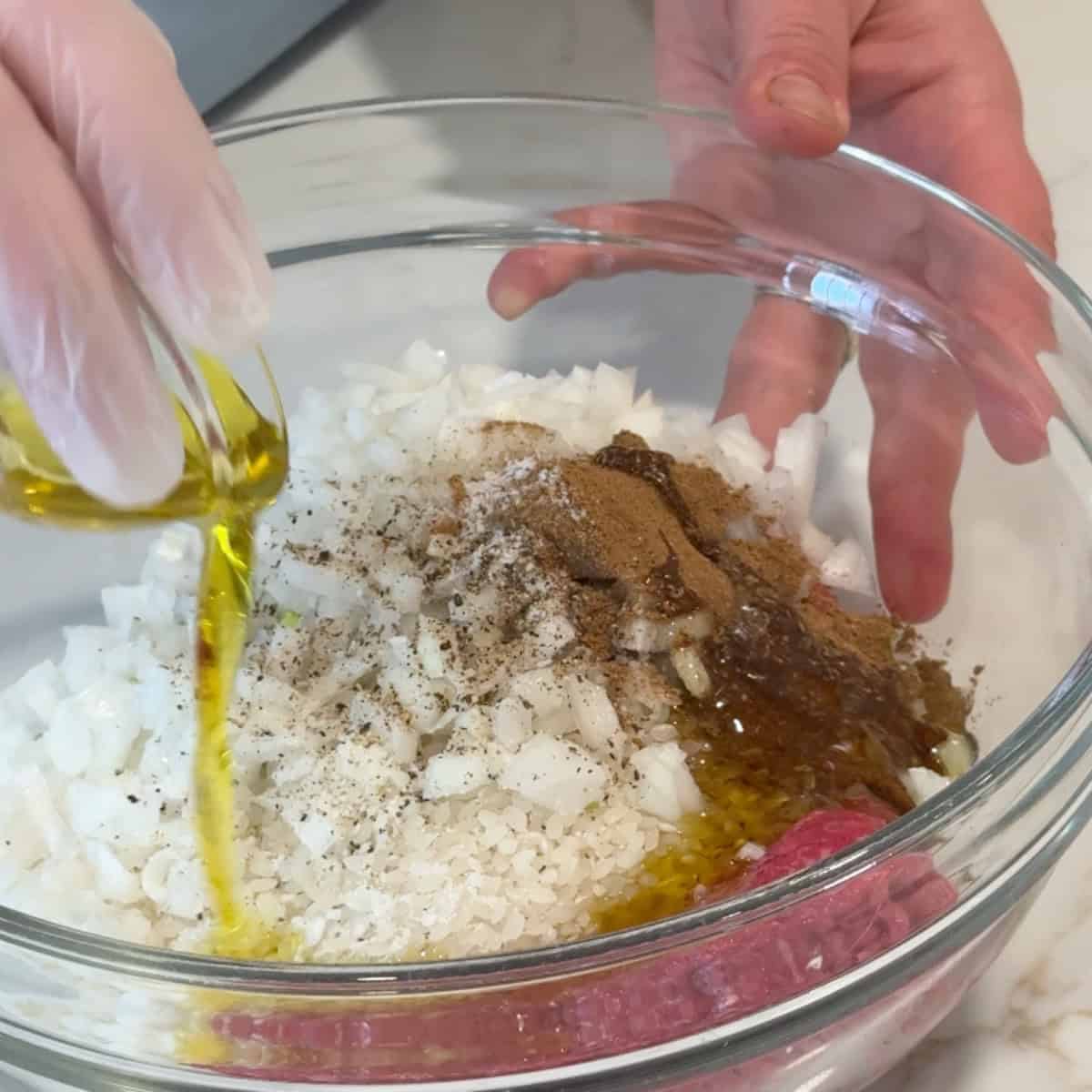 Add olive oil to the ground beef, rice, onions and spices. 