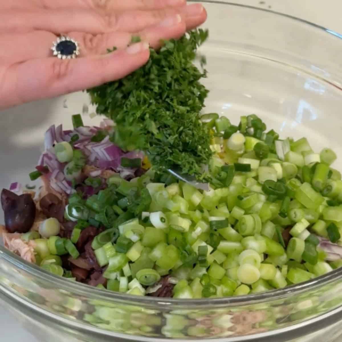 Add the herbs to the tuna and vegetables. 