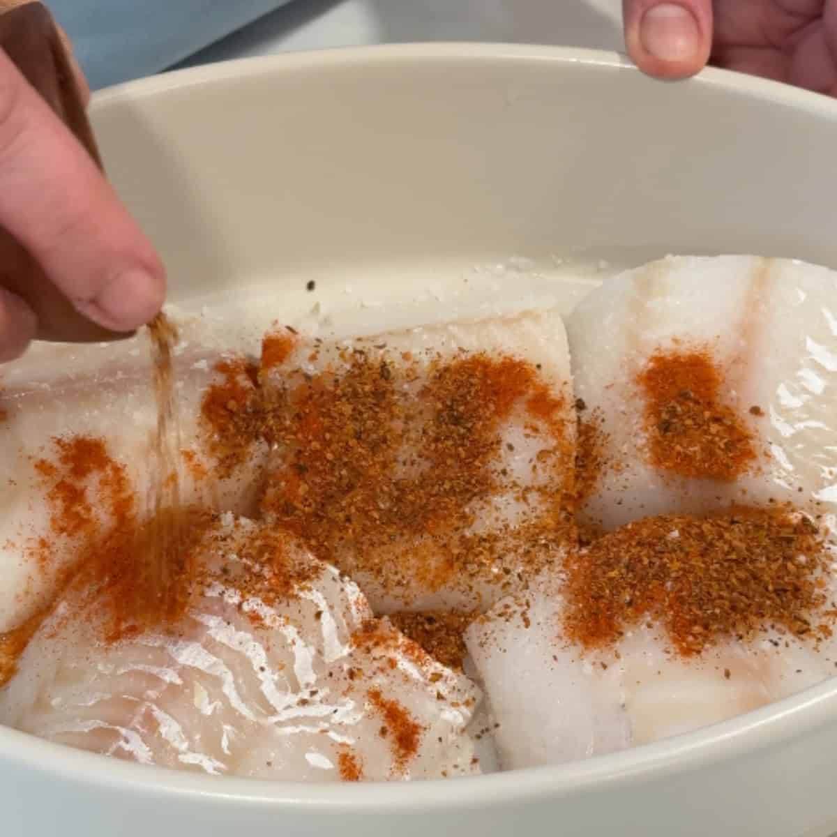 Season the fish with spices and olive oil. 