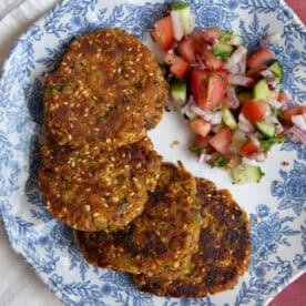 lentil fritters on a plate with salad.