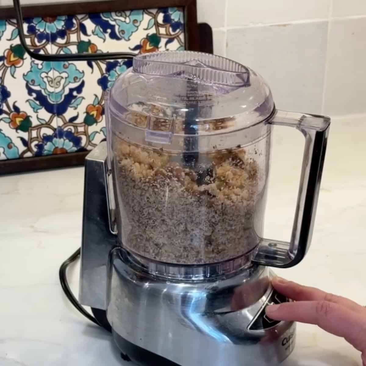 Chop the walnuts in a food processor. 