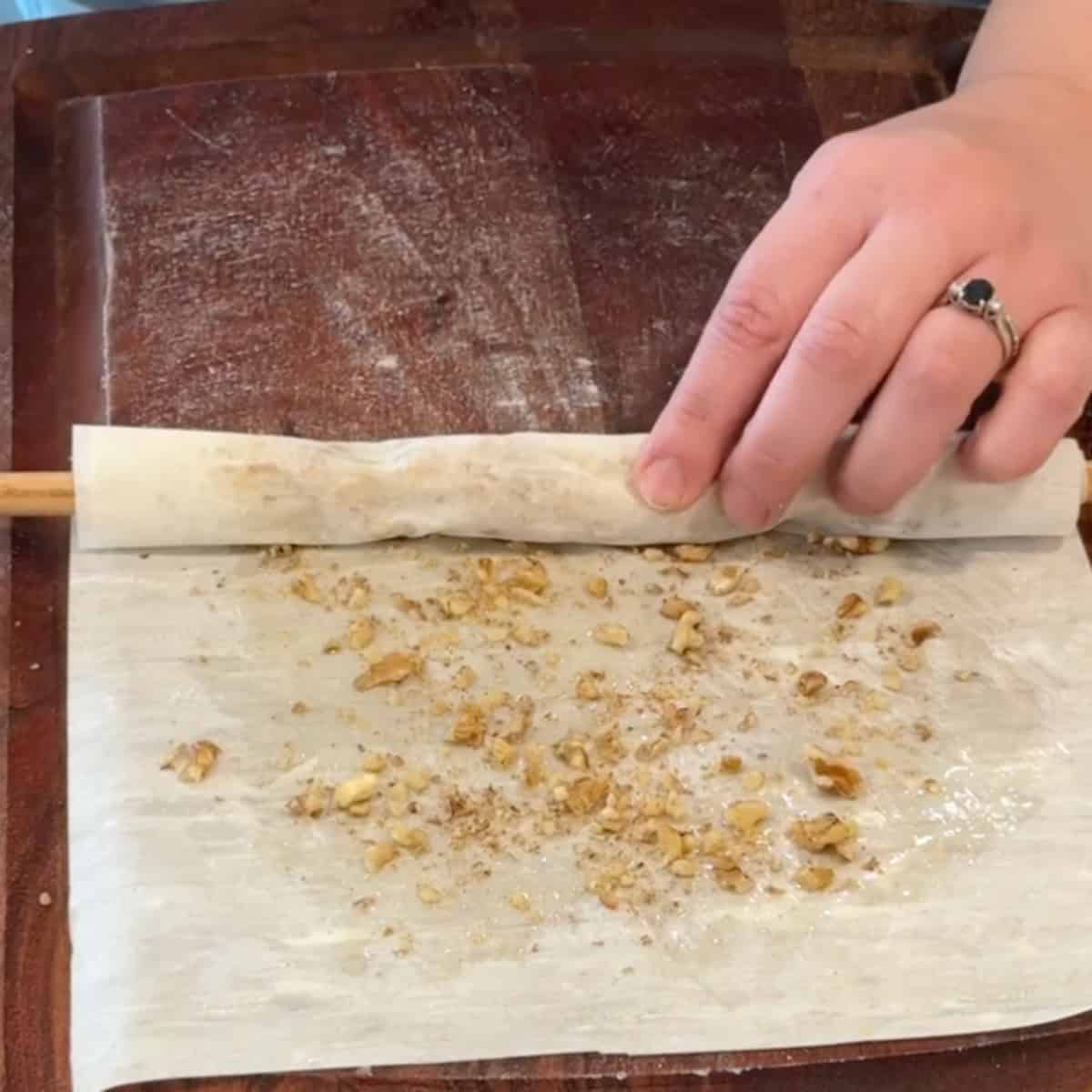 Brush the phyllo with butter and top with walnuts