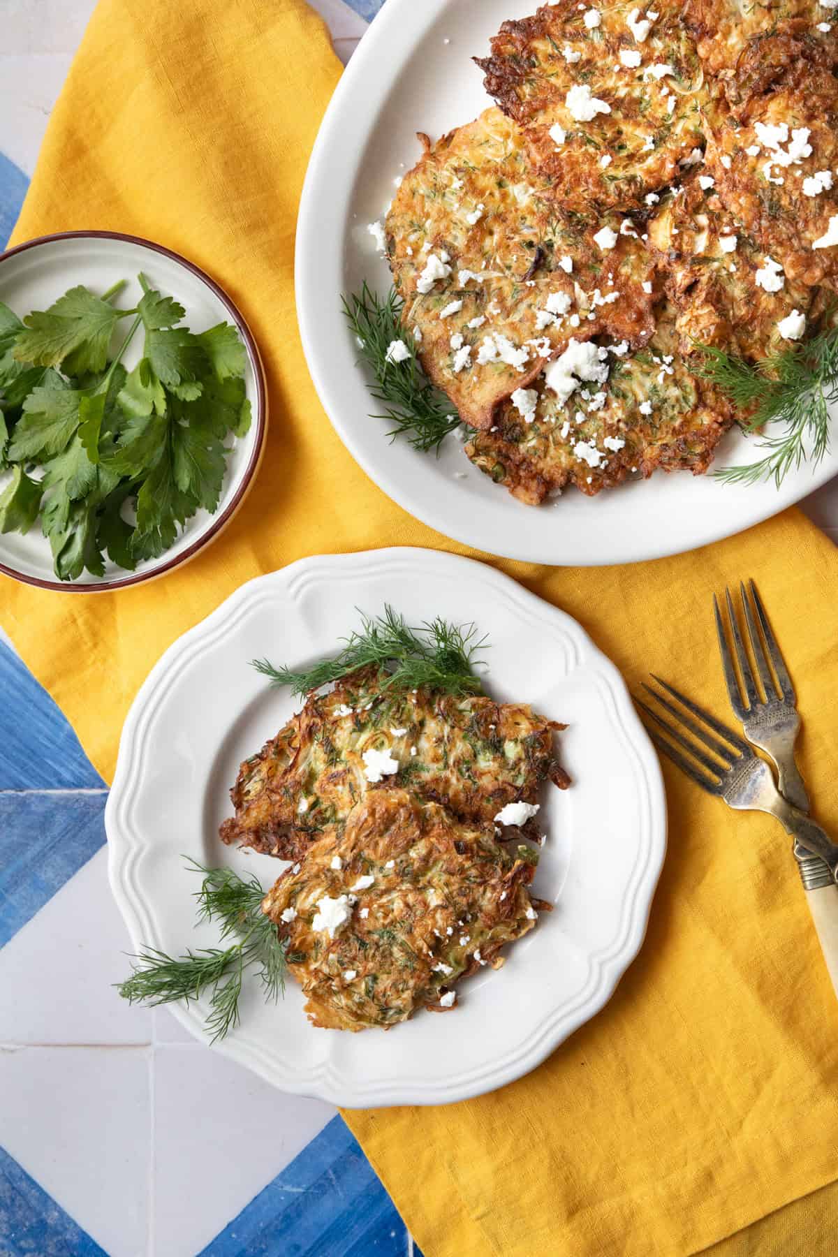 A plate and platter of cabbage fritters. 