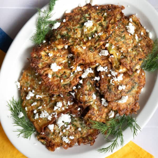 Cabbage fritters on a white oval platter.