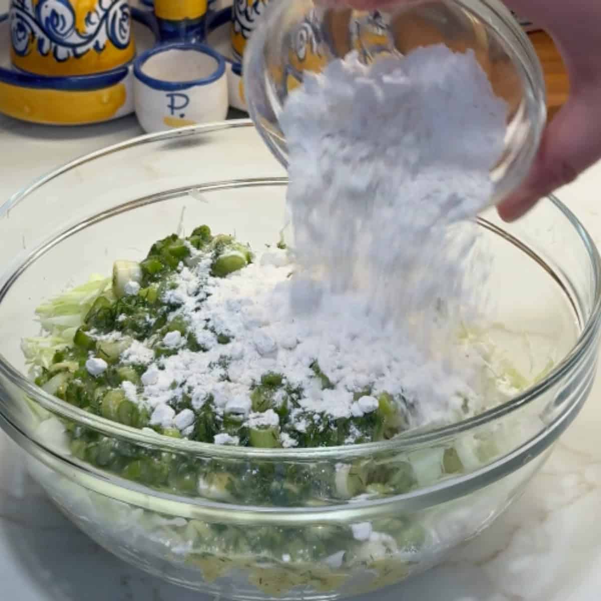 Add the spices and flour to the cabbage. 