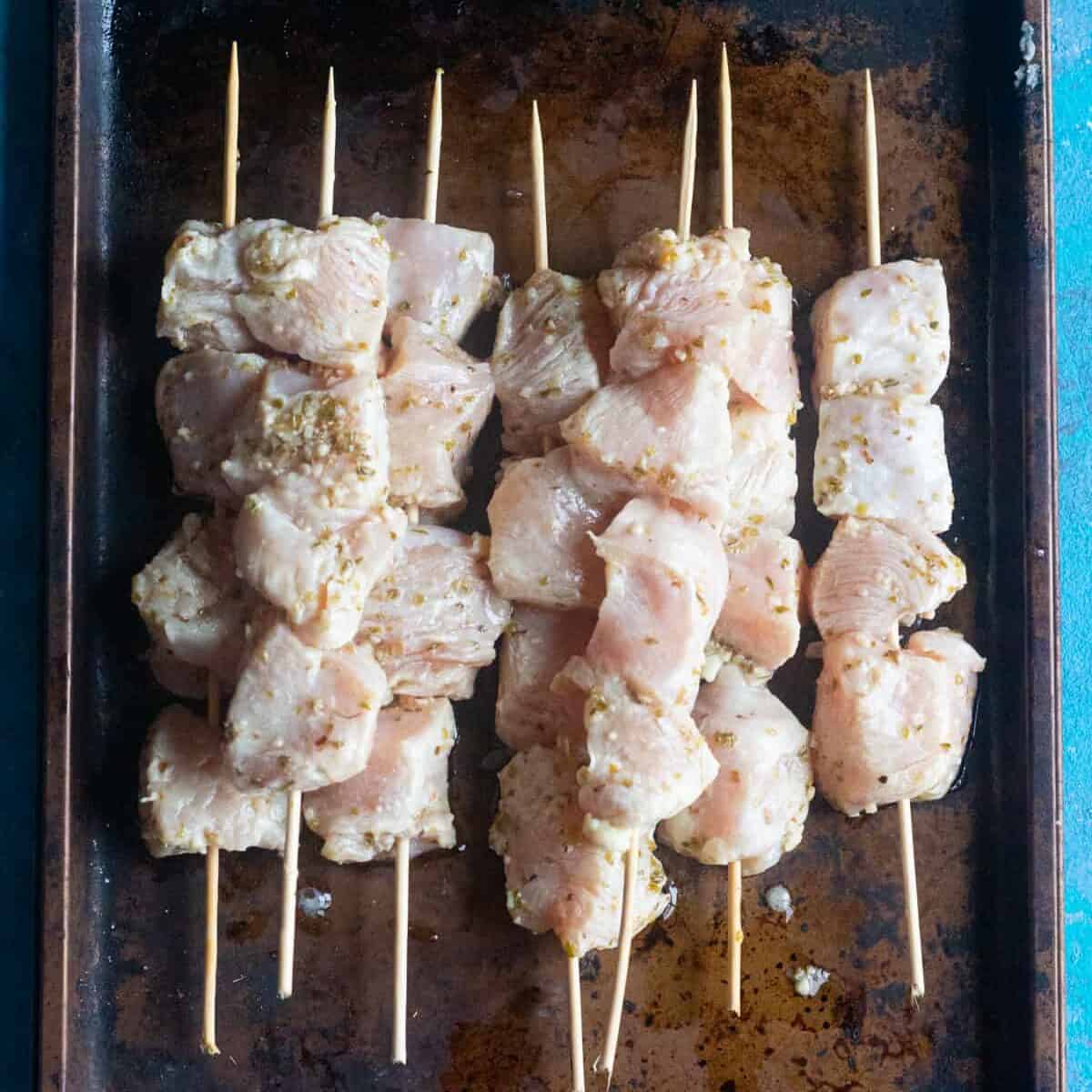 thread the chicken on wooden skewers. 