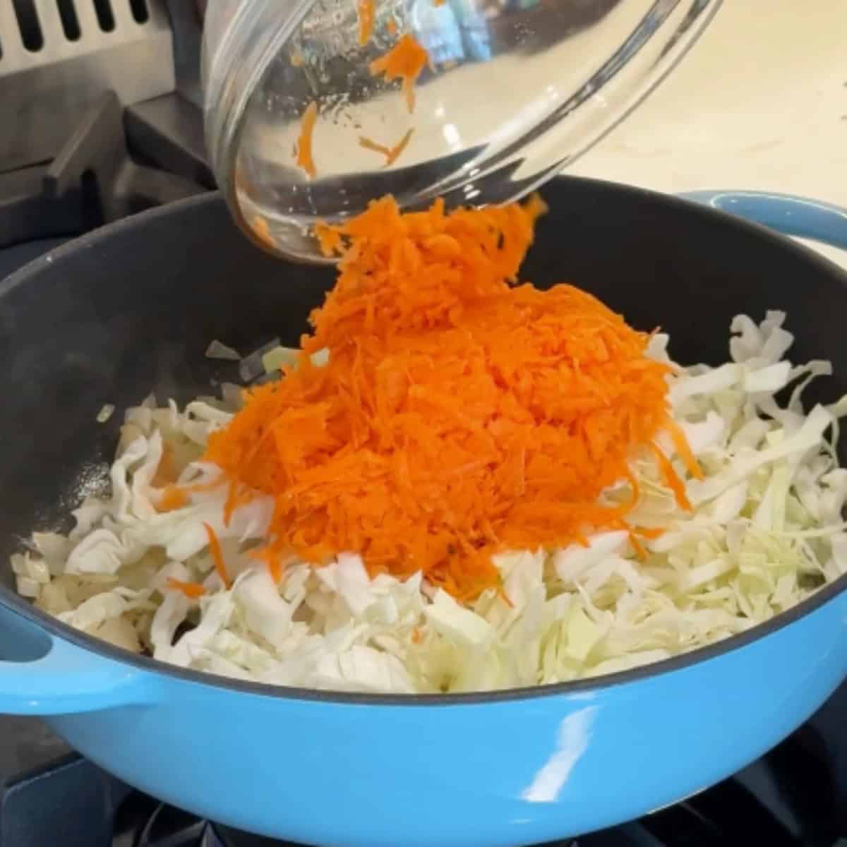 Add the cabbage and carrots. 