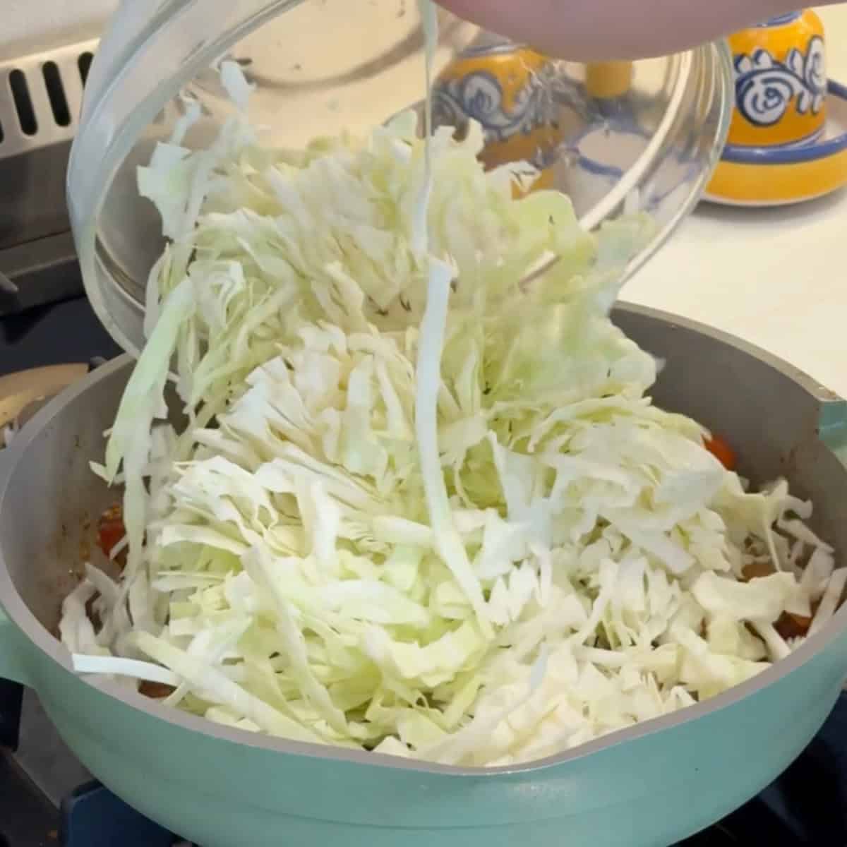 Add the thinly sliced cabbage. 