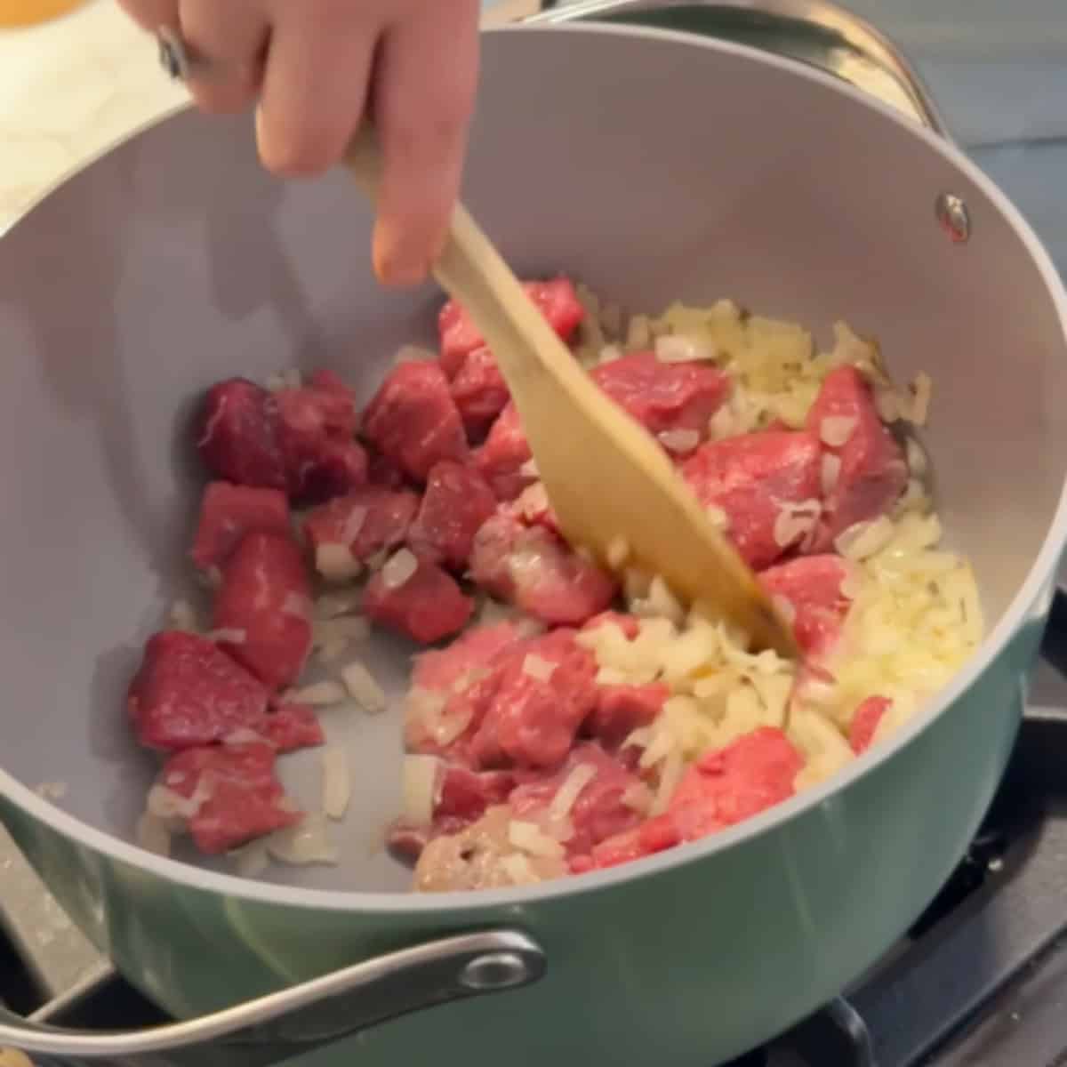 Add the lamb to the onion. 
