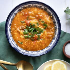 unstuffed cabbage soup in a blue bowl topped with parsley.