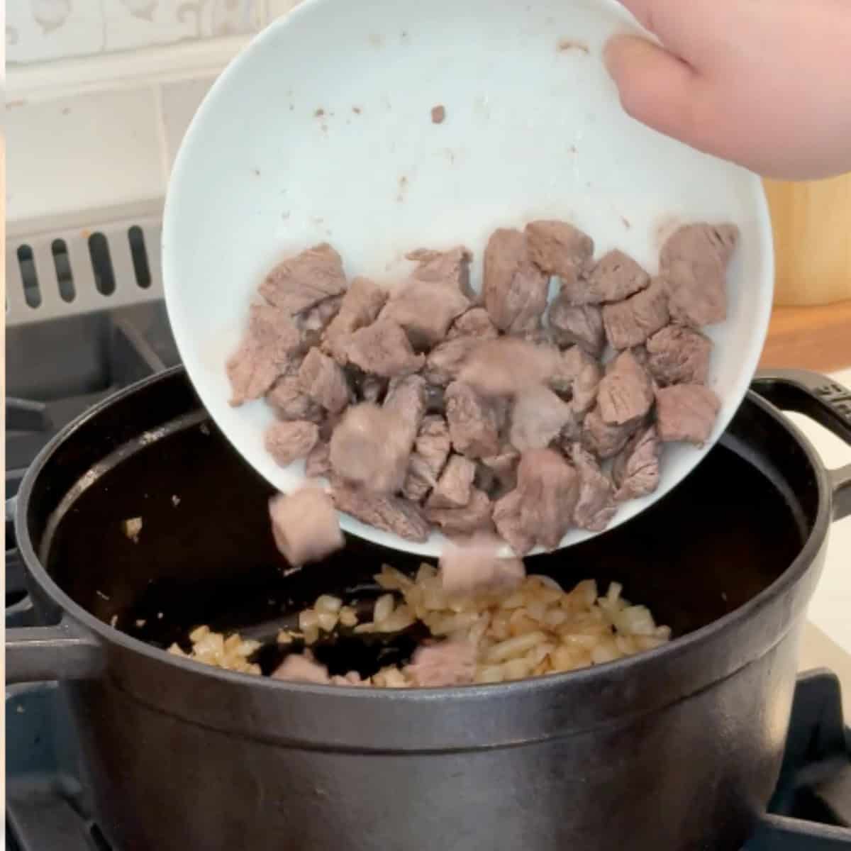 Add the seared beef back to the onion.