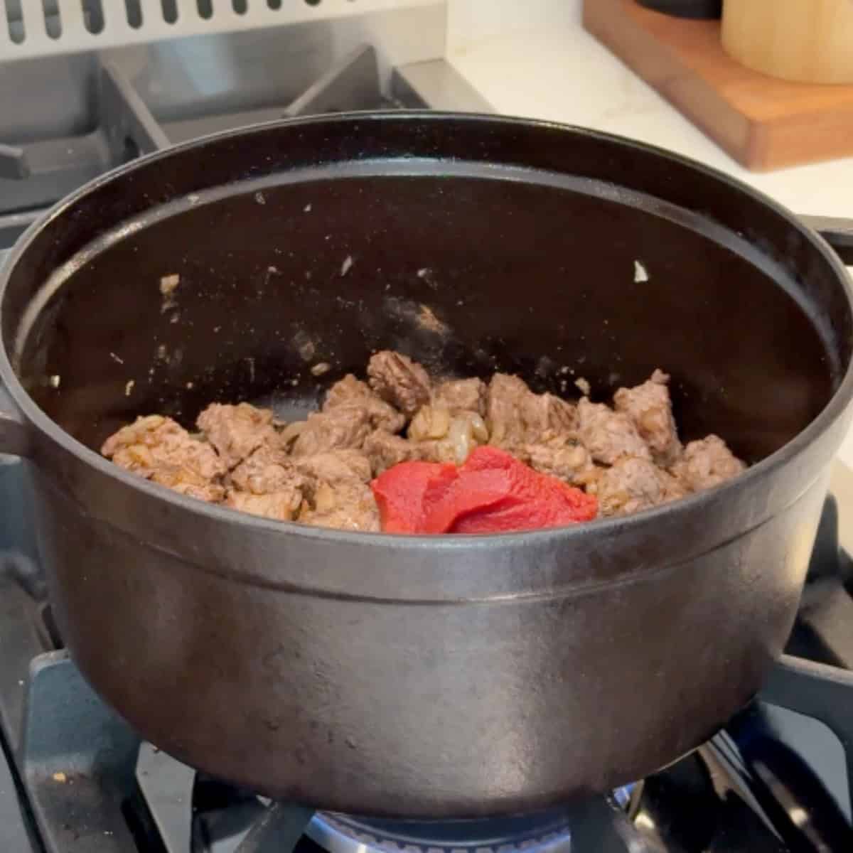 Add the spices and tomato paste.