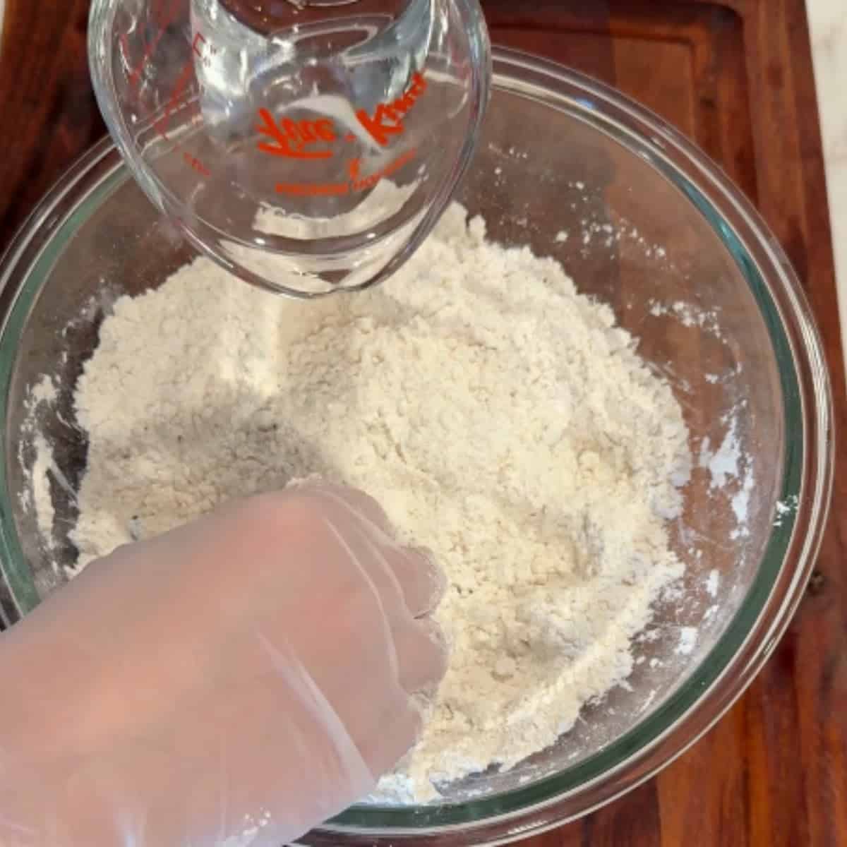 add the water to the flour and ghee mixture.