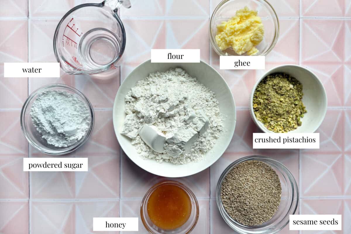 To make barazek you need all purpose flour powdered sugar ghee water honey sesame seeds and pistachios.