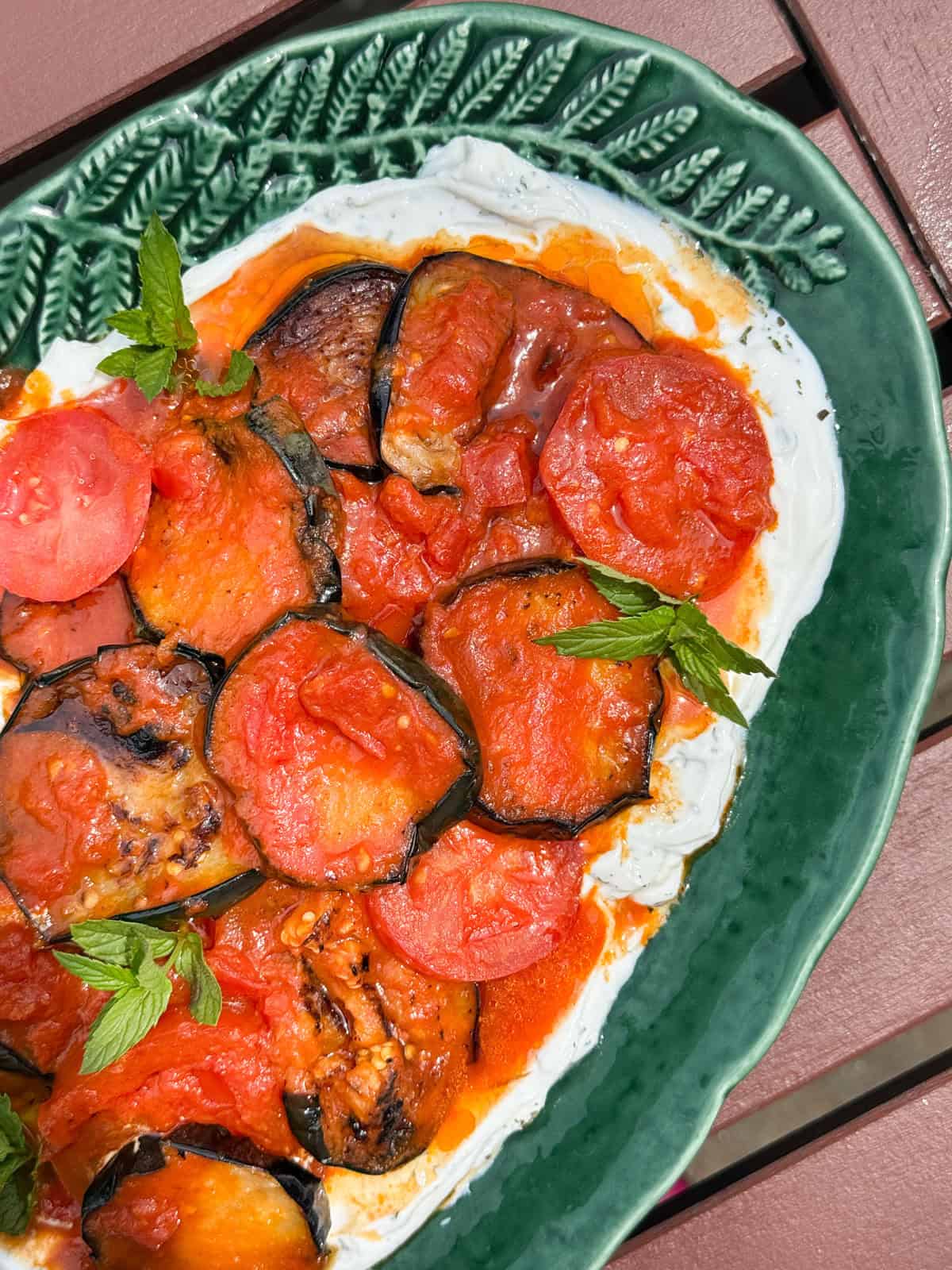 Borani banjan served on a green platter.