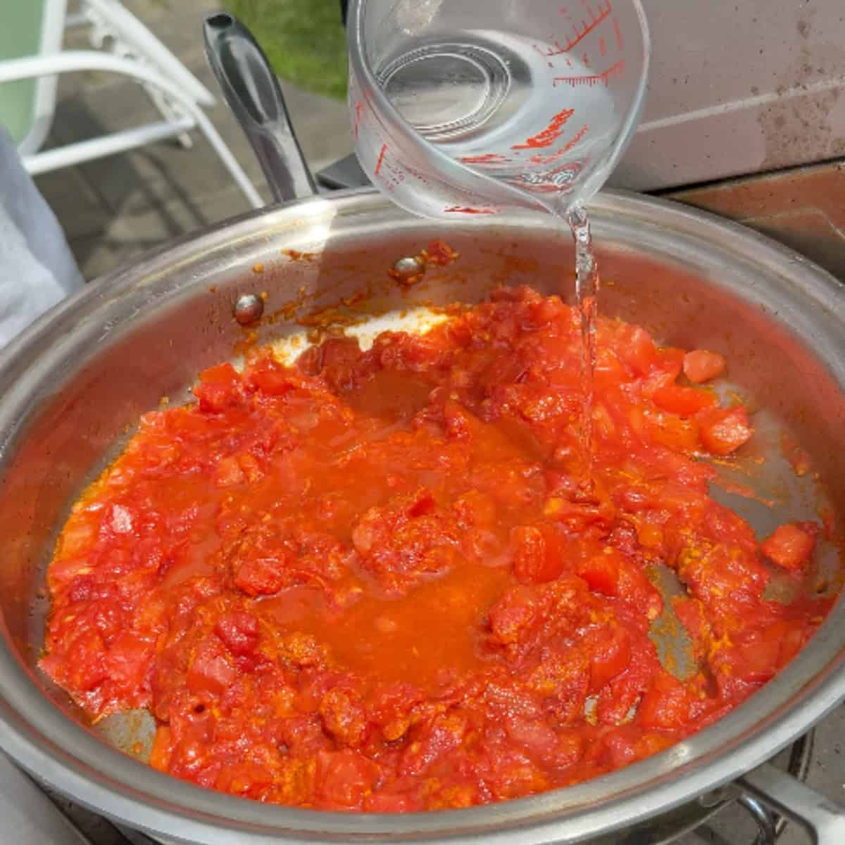 Add water to the tomatoes and cook