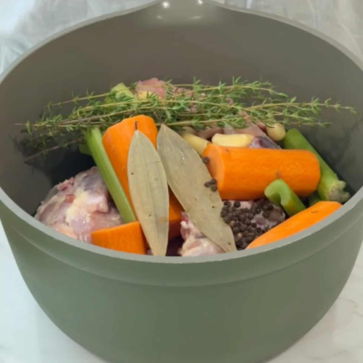 place the chicken, vegetables and herbs in a pot. 