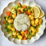 Turmeric lemon chicken soup in a bowl with rice.