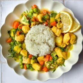 Turmeric lemon chicken soup in a bowl with rice.