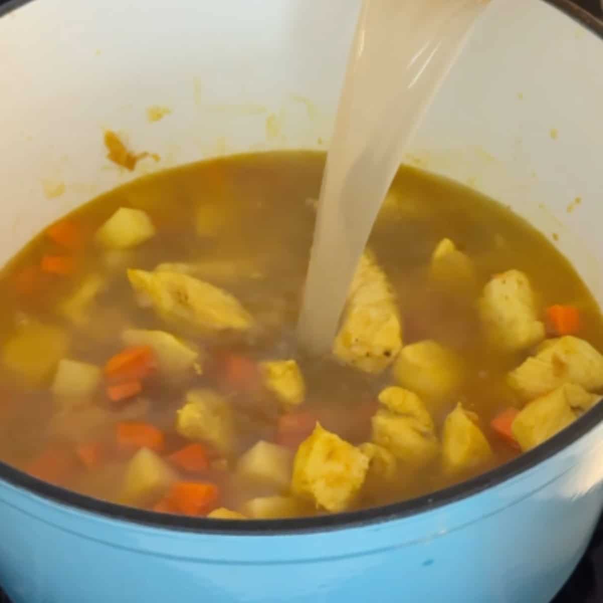Add in the potatoes and carrots followed by the broth. 