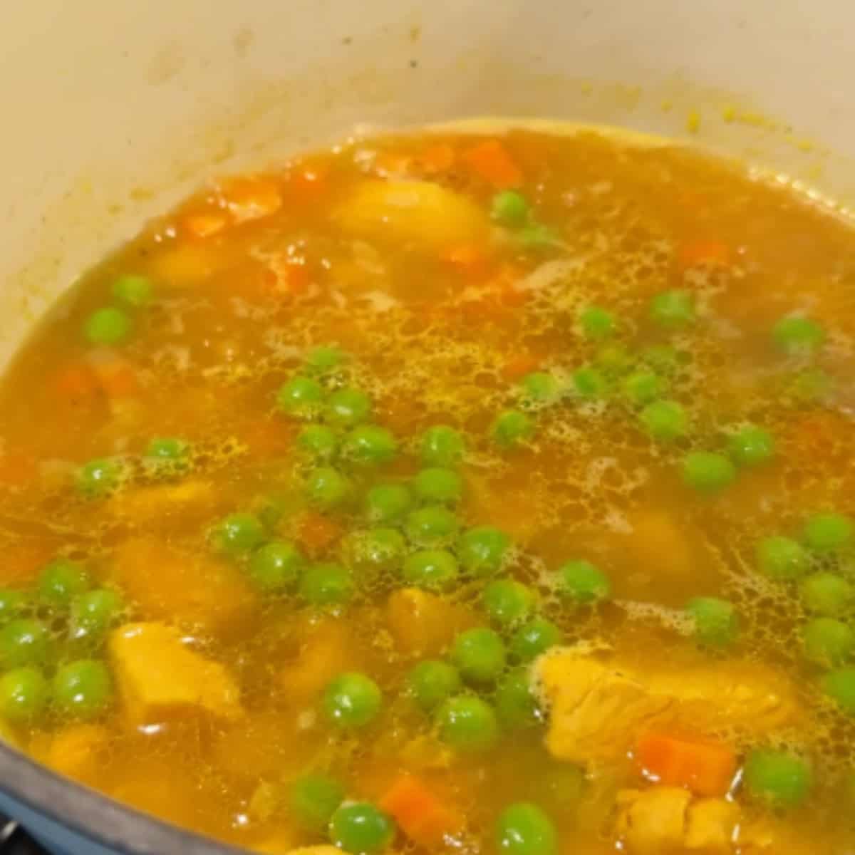 Once everything is cooked, add in the green peas. 