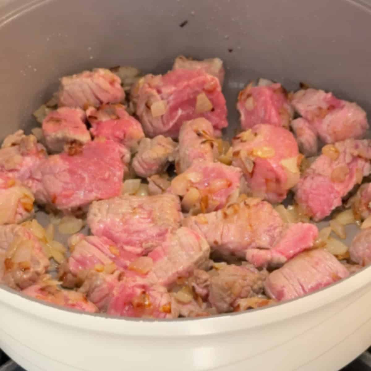 cook onion and beef until changes color.