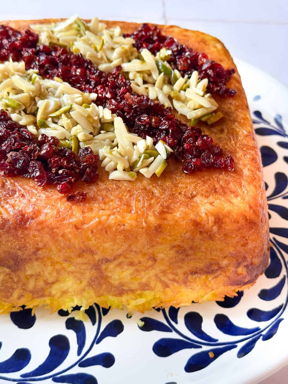 Eggplant tahchin topped with barbarries and nuts.