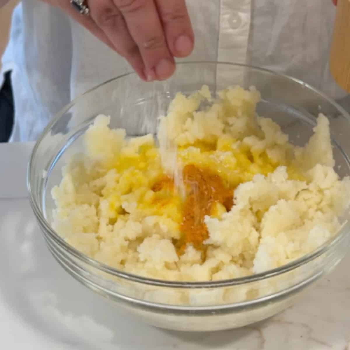 Mash the potatoes, add in the spices and eggs and flour.
