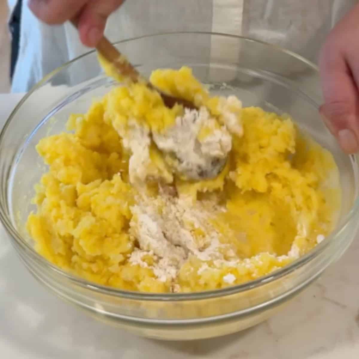 add in the flour to the potatoes