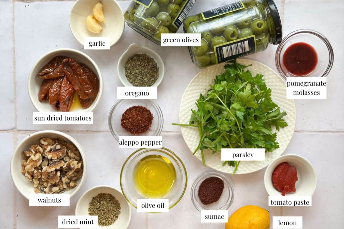 to ake this recipe you need Castelvetrano olives, sun-dried tomatoes, olive oil, lemon juice, pomegranate molasses, garlc, spices and walnuts and parsley.